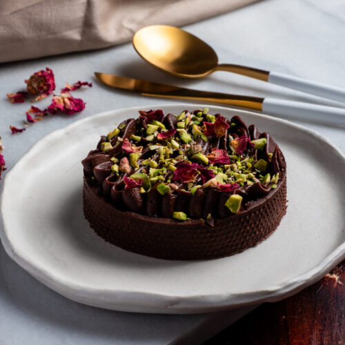 Individual Dubai chocolate tarts with pistachio kataifi filling and dark chocolate shell