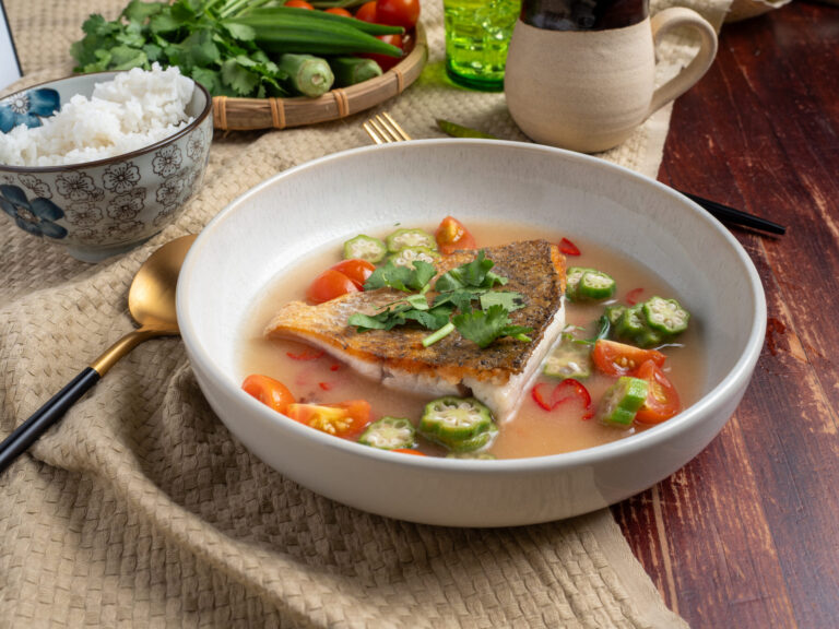 Canh chua Vietnamese sweet and sour soup with fish, okra and tomato in a bowl