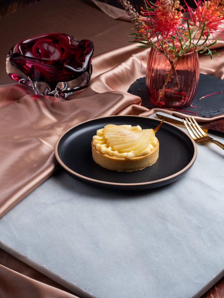 Individual pear and almond tart with frangipane filling and poached pear
